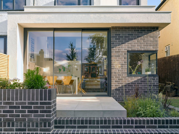 Rear exterior of a renovated London home with ample glazing