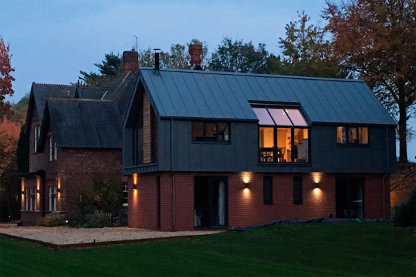 Timber frame clad in brick and zinc